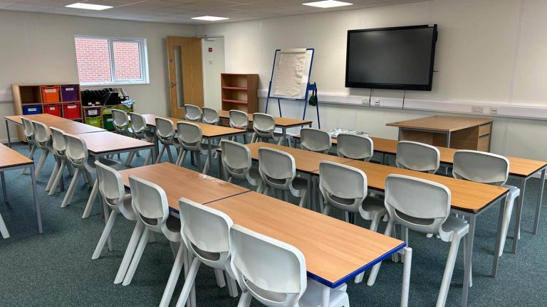Fitted out modular classroom interior at Advantage Schools with interactive screen and floor covering